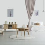 Spacious living room with wooden table on white carpet, rustic cupboard and grey sofa near open bedroom